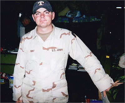 Sergeant Joey Hunt in uniform standing inside military barracks Sergeant Joey Hunt in uniform standing inside military barracks